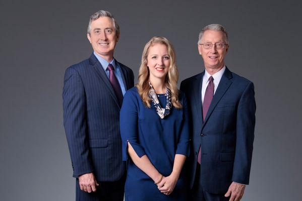 Greg Enos (far right) leads an attorney team
that includes his brother, Paul Enos,
and daughter, Catherine Enos Healy.