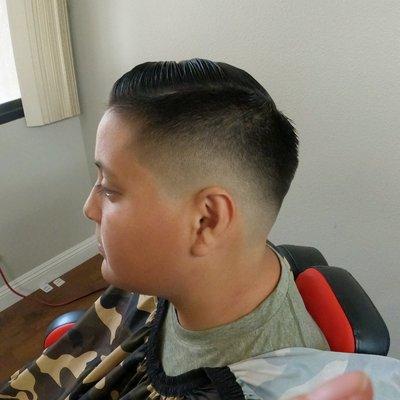 Medium skin fade comb over with the hard part