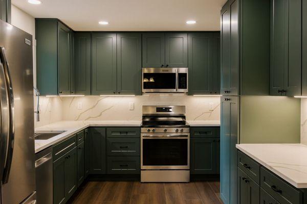 Modern green cabinetry with quartz countertops -- a full kitchen remodel in Vancouver, WA built for style + function
