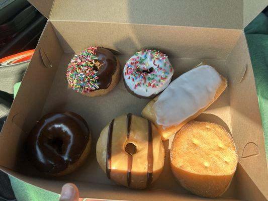 Apple pie filled doughnut, cream filled vanilla long John, chocolate striped Carmel doughnut.