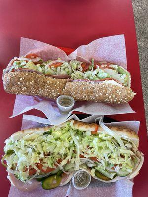 Bottom: Veggie sub on Asiago bread with an add of turkey and provolone; Top: The Enterprise