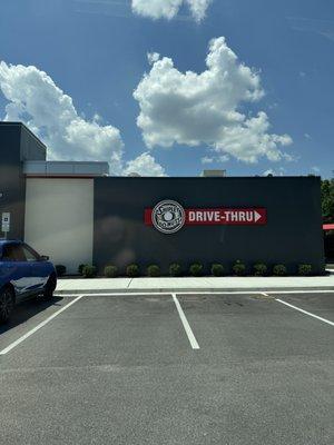 Drive-thru signing on the side of the building.