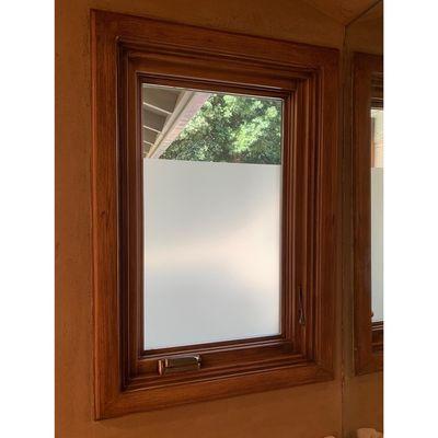 A bathroom window treated with Huper Optik Dekorative frost to add privacy.