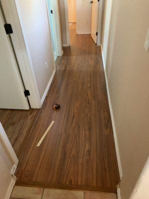 Repair/replacement to laminate that had to be pulled up and replaced after a leak from above warped part of the flooring.