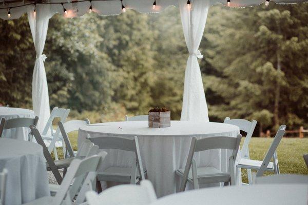 120" linens on 60" round tables with white resin chairs- Photos taken at Woodland Lodge and Farms by Wink Wedding Collective