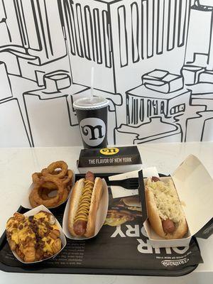 Bacon cheese fries onion rings mustard dog and one with sauerkraut