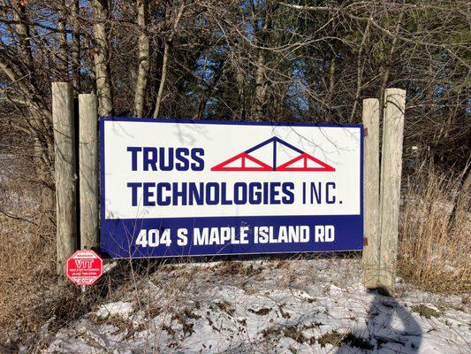 A vibrant outdoor shot showcasing the "Truss Technologies Inc." sign located at 404 S Maple Island Rd...