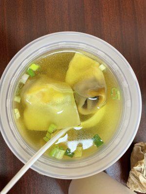 Won ton soup! All food served in plastic containers and plastic fork, knives and spoons.
