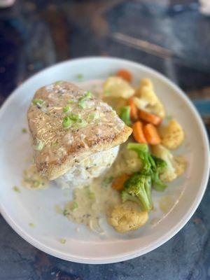 Sea bass over rice with vegetable medley. The sauce is to die for!!