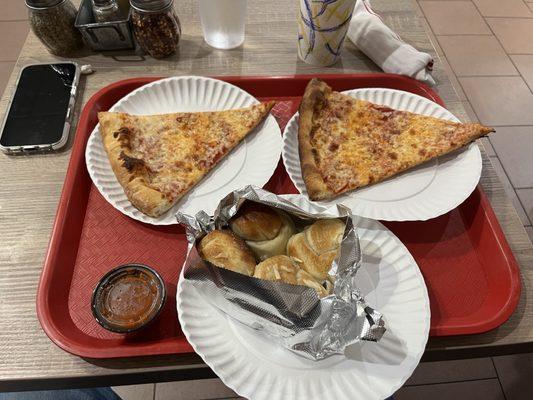 Cheese pizza slices and garlic knots.