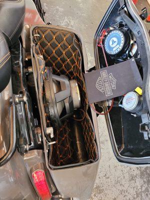 Customizing with fiber-glass and Adding a 10 inch subwoofer and speakers in the saddlebag for a Harley.