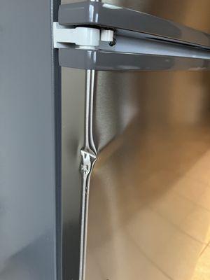 Gouges and more dent on refrigerator, yelp only allows 10 pics