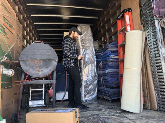 Organizing customers furniture on truck.