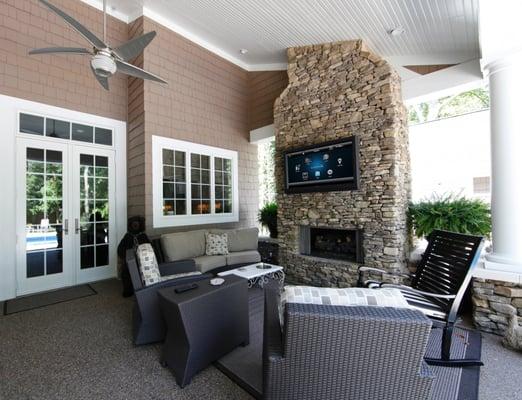 Outdoor TV mounted in a covered patio, controlled by Control4