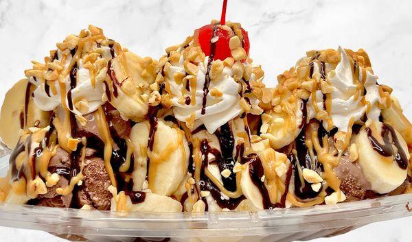 The Elvis:
2 scoops choc & 1 scoop vanilla ice cream, chopped bananas, hot fudge & pb drizzle, whipped cream, chopped nuts, & cherry