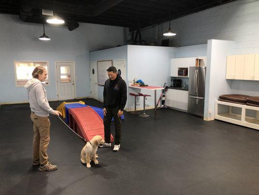 Our Trainer Alex talking with one of our students in the training room before class.