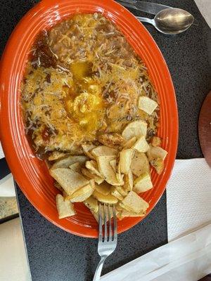 Huevos rancheros, eggs over easy & crispy potato slices.