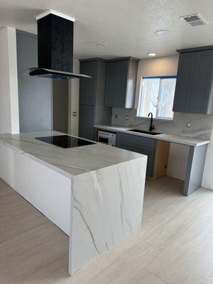 Quartzite kitchen countertops with waterfall and full sbab backsplash