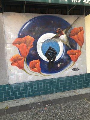 Bird, red flowers, clenched fist in space