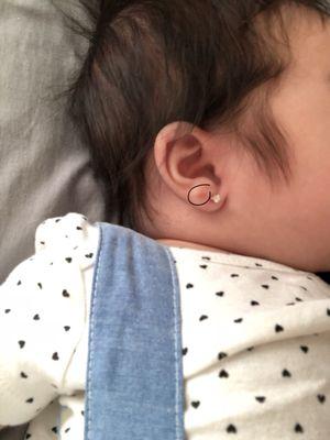 Where I circled in the picture, you can see the red swollen mark where she originally pierced my daughters right ear! UNACCEPTABLE!!!