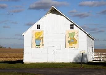 Barn Quilt paintings seen from the Highway! Guests helped create paintings. My g-daughter's name is on the Sue quilt.