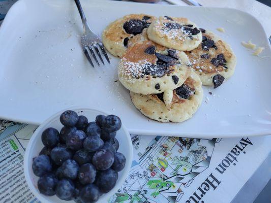 Silver dollar oreo pancakes with a side of fresh blueberries.