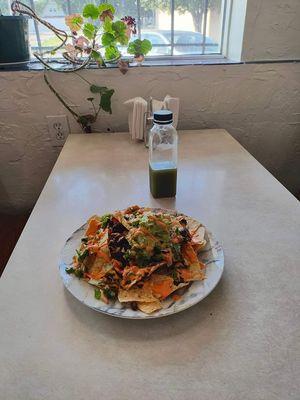 The nachos are GF & vegan; chips, beans, fresh guacamole, & vegan queso sauce.
