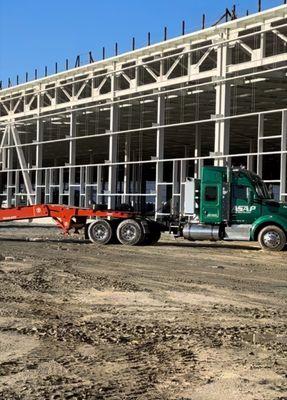 Loading containers on job site for towing transport