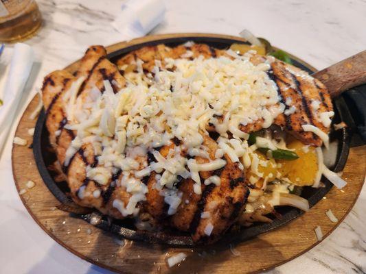 El Potosino. Chicken, shrimp, cheese sauce and cheese. Over vegetables, which were peppers and onions. Served with rice and beans.