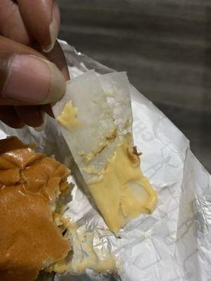 Paper was in my food. I bit into my food & this came out of my burger. I am disgusted. no one answered phone when called This is a hazard!