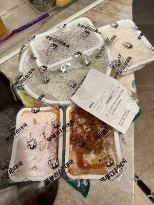 Soup, glass noodles , rice, kimchi, and Korean radish all prepackaged containers