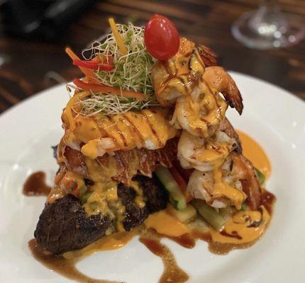 Filet mignon topped with lobster and grilled drink skewers topped with lobster sauce . To die for !!!!