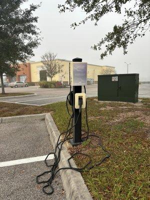 Sad non-NACS (North America Charging Standard) charger next to Tesla supercharger, for comparison. Looks broken, as is usually the case.