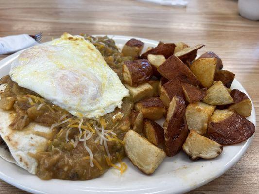 Huevos rancheros with 1/2 & 1/2 green chili (mild and spicy) and country fried potatoes