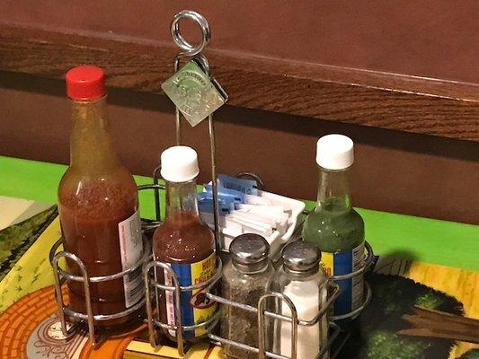 Salsas and stuff on each table.