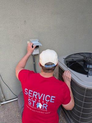 Our Tech making sure putting the finishing touches on an AC install.