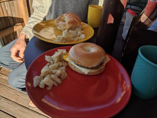 Breakfast sandwiches - one on a bagel and one on a croissant.