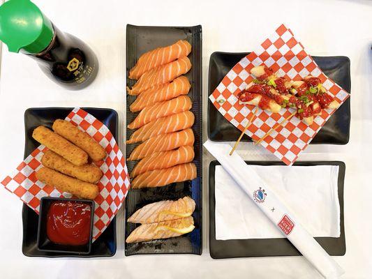 Cheese sticks, salmon nigiri , seared salmon nigiri, spicy rice cake skewers