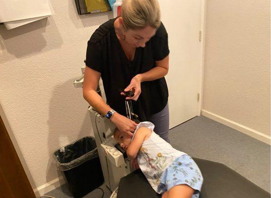 Dr. Gray doing an atlas adjustment on my four year-old