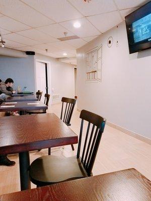 Tables and chairs are well spaced and large screen TV playing Asian tvs : )