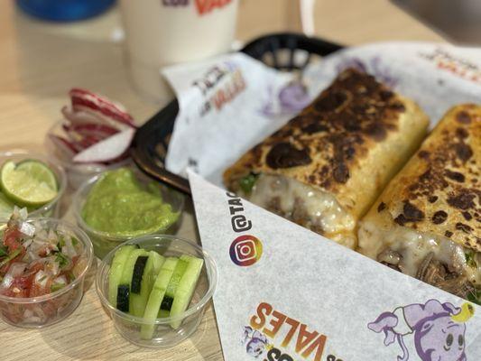 Birria burrito with salsa, limes, radishes, cucumbers, and FREE GUACAMOLE