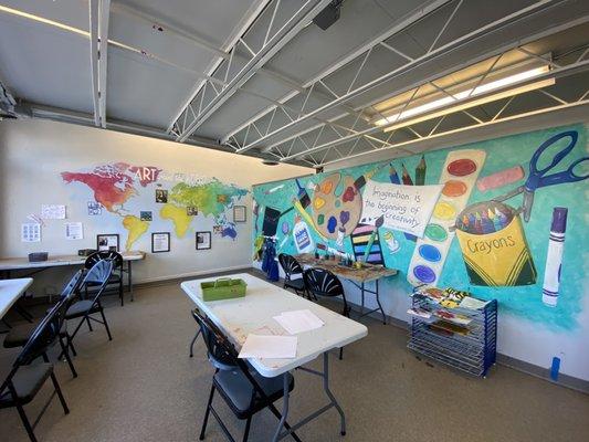 The art space. There were areas for painting, coloring, and making crafts. We made a bumble bee out of a toilet paper roll.