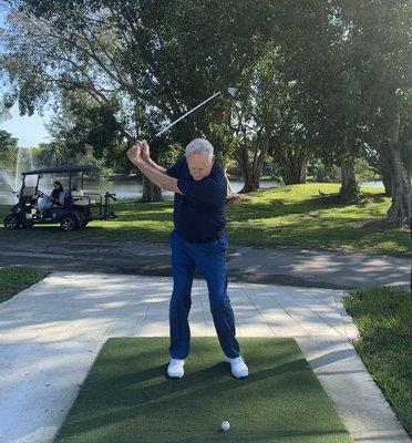 Richard Metz at the top of the back swing with a short iron.