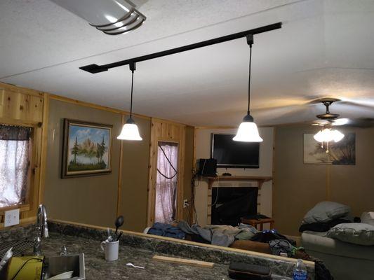 Custom sliding pendant lights on a slanted ceiling.