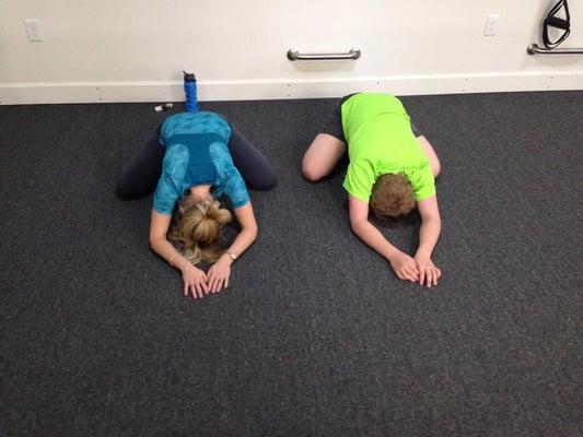 Mother and son stretching post-class
