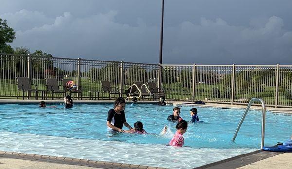 Instructor teaching swim lessons at Aliana subdivision