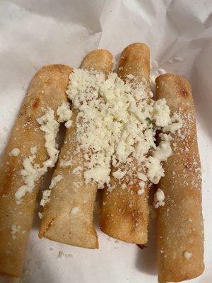 Flautas-rolled corn tortillas, deep fried until crispy, with chicken filling, topped with cheese/etc.