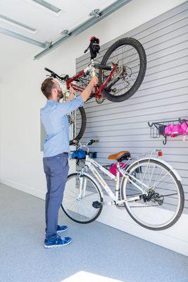 No more garage chaos! Our personalized garage storage makes cleanup a breeze, like this slat wall.