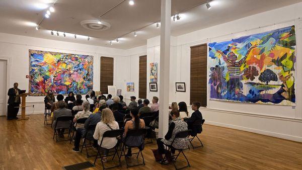 "Opening reception for the 'Roots and Realities' exhibit, featuring an artist conversation."