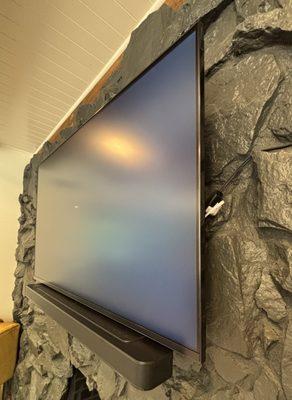 TV installation and soundbar on stone